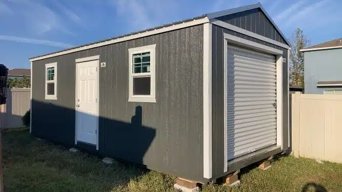 a grey 14x24 garage shed with white trim and white doors for sale in florida