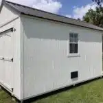 backside of a cabin shed with a double door on the back