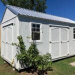 white lofted side gable shed with two windows and two sets of double doors