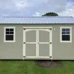 side gable lofted shed with two windows and a metal roof