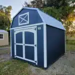 a blue barn shed with white trim and a metal roof in labelle fl