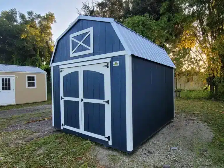 a blue barn shed with white trim and a metal roof in labelle fl