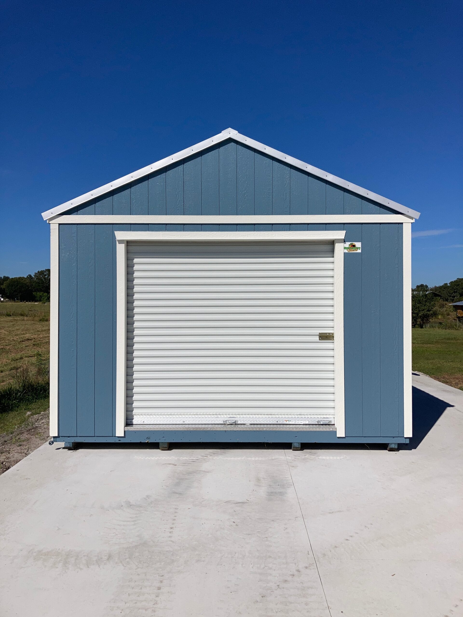 blue side lofted gable shed with roll down door scaled