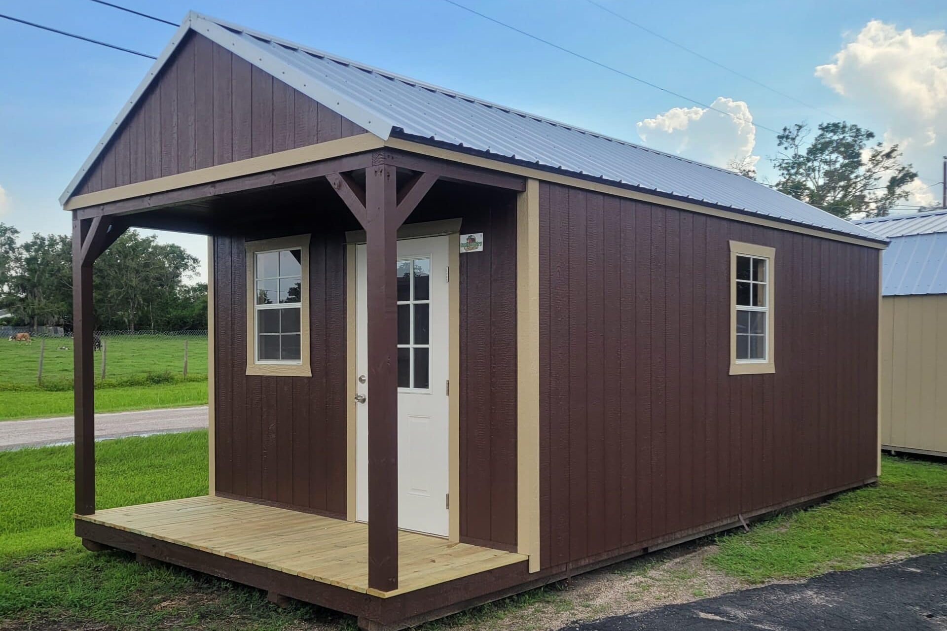 brown cabin in loxahatchee fl with wooden trim and front porch