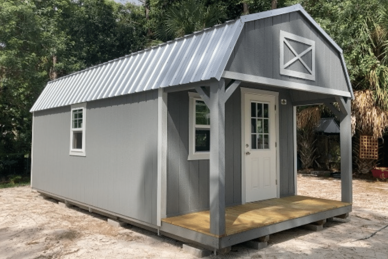 gray cabin shed with windows, door, and porch in miami fl