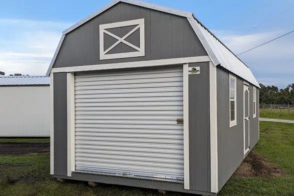 dark gray garages in loxahatchee fl with white garage door and white x mark on top of barn style roof