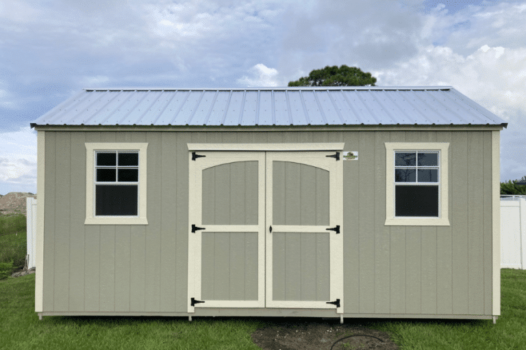 gray shed with cream colored trim and black metal roof