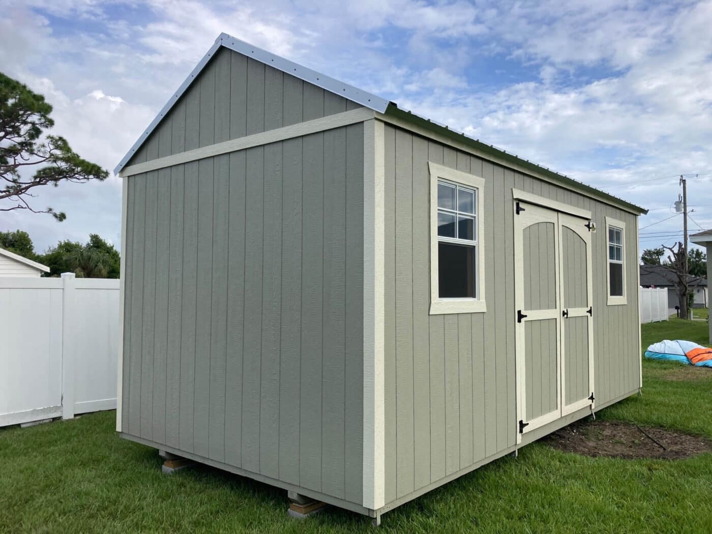 a grey, hurricane-rated shed with a metal roof