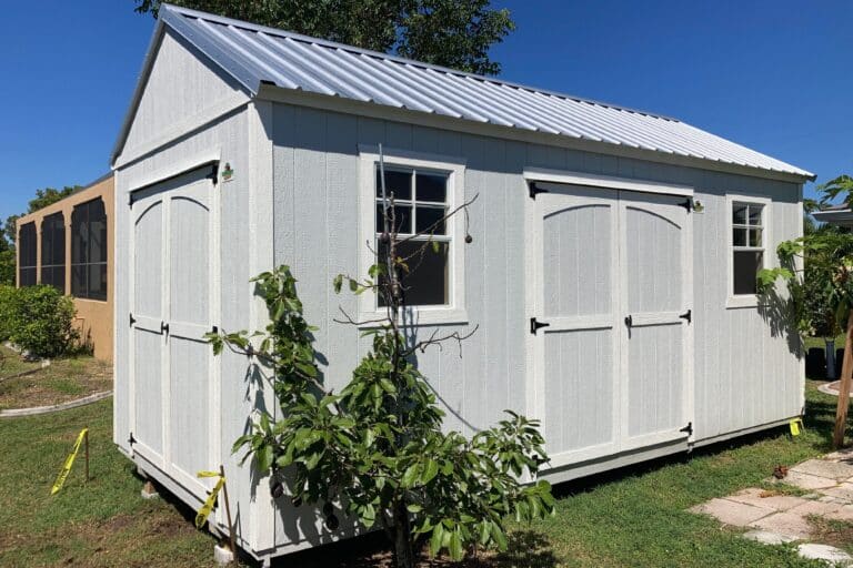 light blue side gable lofted shed with white trim