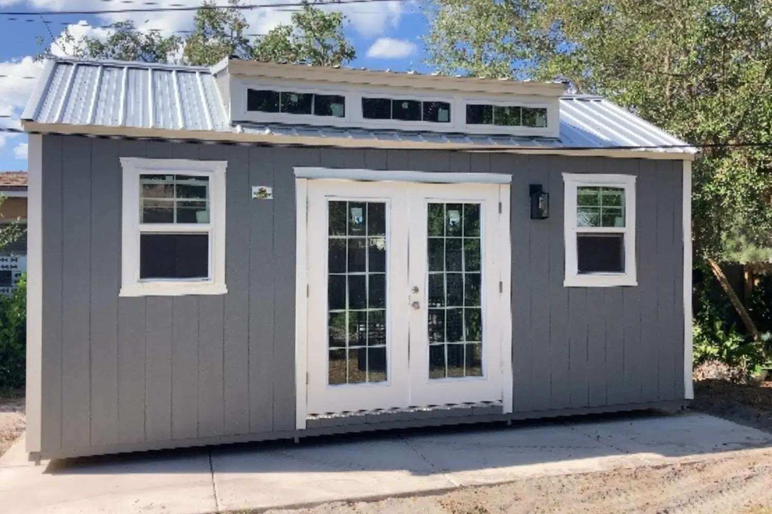 gray storage shed with windows and double doors in haines city fl