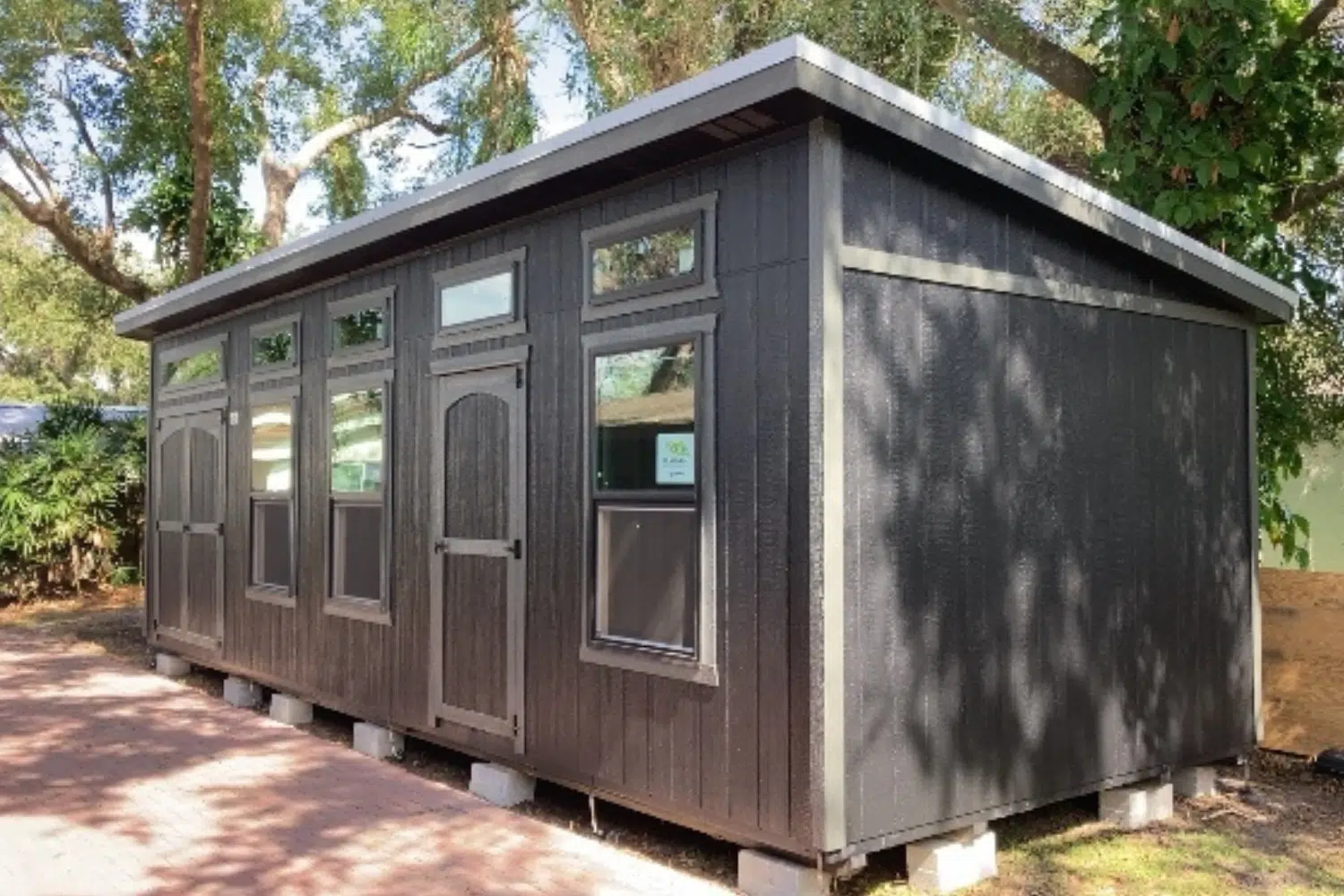 large gray studio shed with many windows in haines city fl