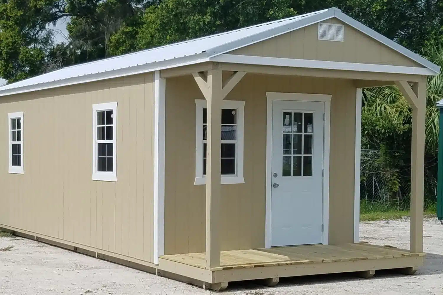 tan cabins in myakka city fl with white trim and a front porch