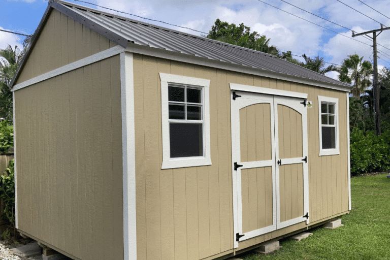 tan side lofted gable shed with white trim and a metal roof